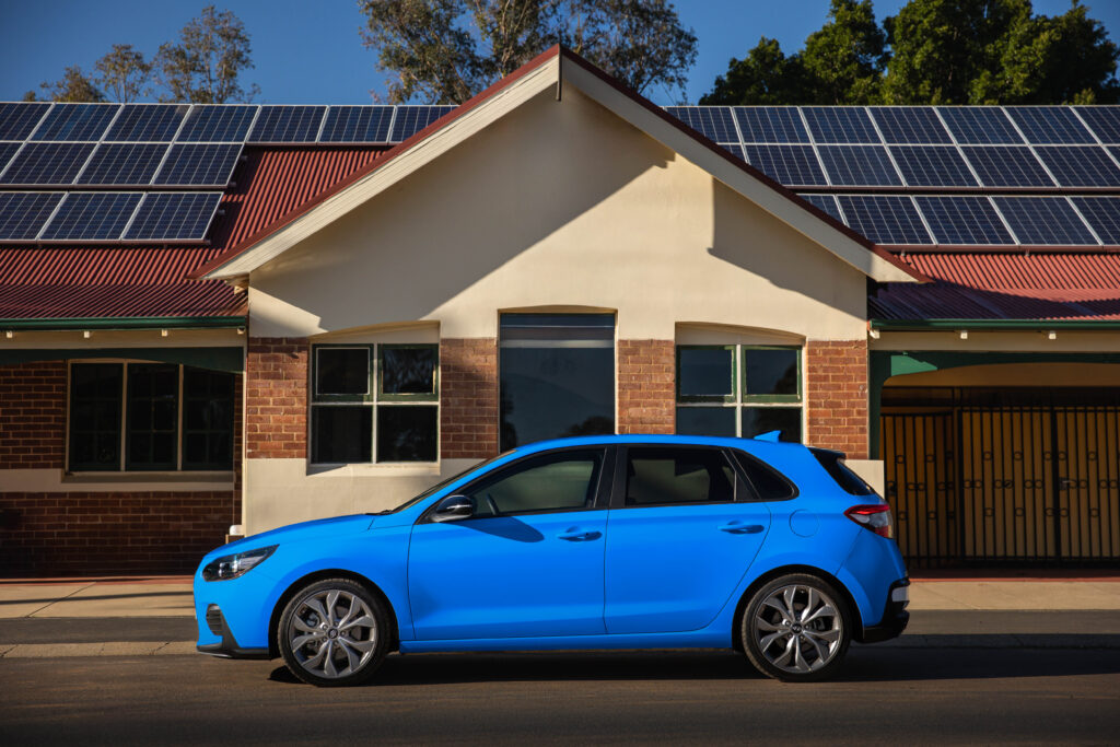 Hyundai i30 blue or a heavily edited image of a car in front of the Boyanup Tavern.